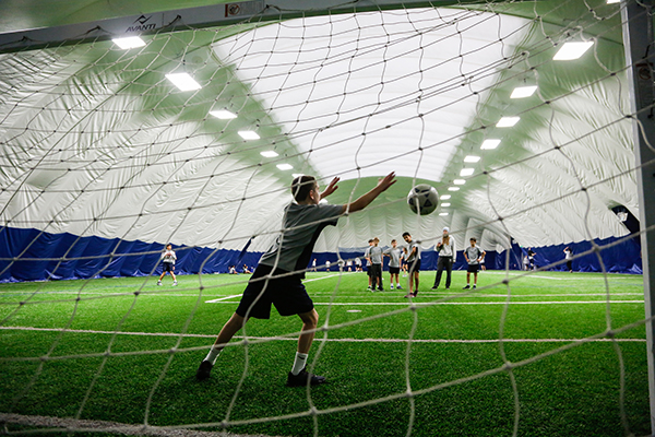 Grade 7 boys playing indoor soccer in the dome