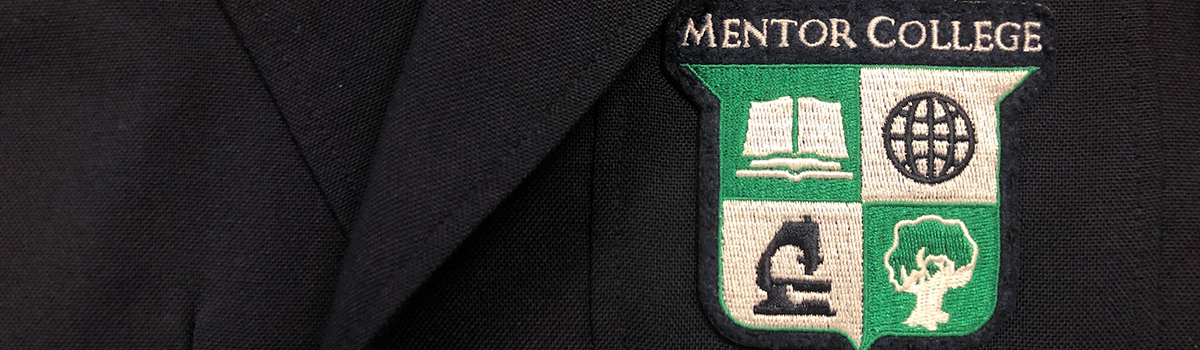 Close-up of Mentor College crest on student blazer