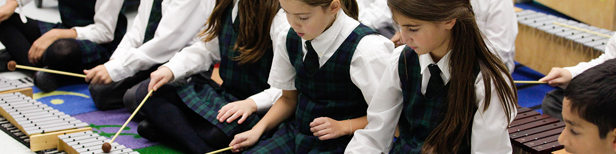 Kindergarten children playing xylophones