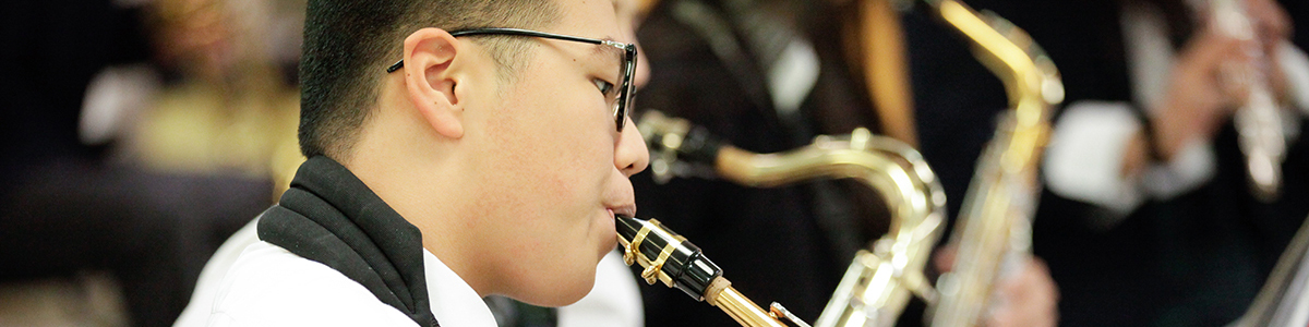 High School boy playing saxophone in class