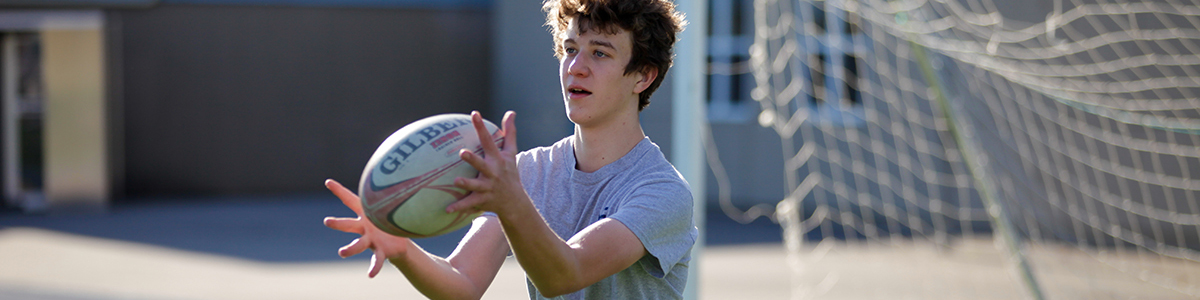 High School boy on the field for Phys Ed class