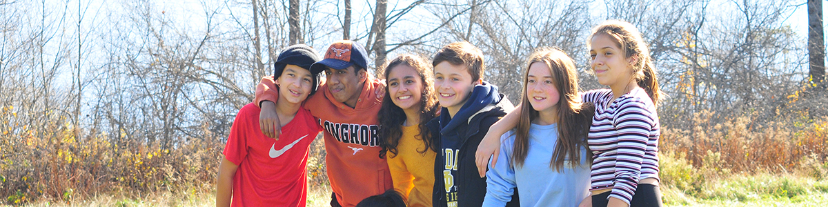 A group of students huddled together on the field