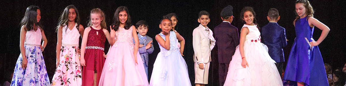 Primary Division boys and girls on stage at annual charity Fashion Show