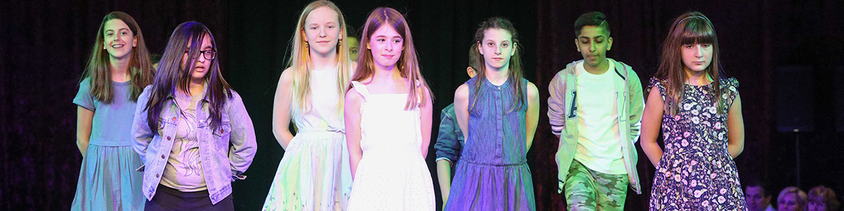 TEAM School boys and girls on stage at annual charity Fashion Show
