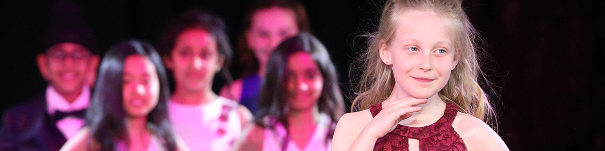 Primary Division girl on stage at annual charity Fashion Show