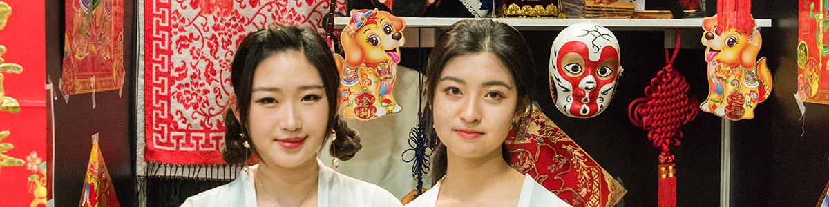 Two girls in front of the China pavilion at the annual Celebration of Cultural Diversity