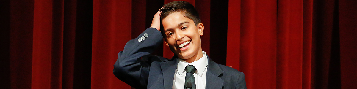 Intermediate Division boy on stage at annual Speech Competition